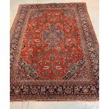 A Kashan Carpet, West Persia, the madder field with a central indigo lobed pole medallion, with