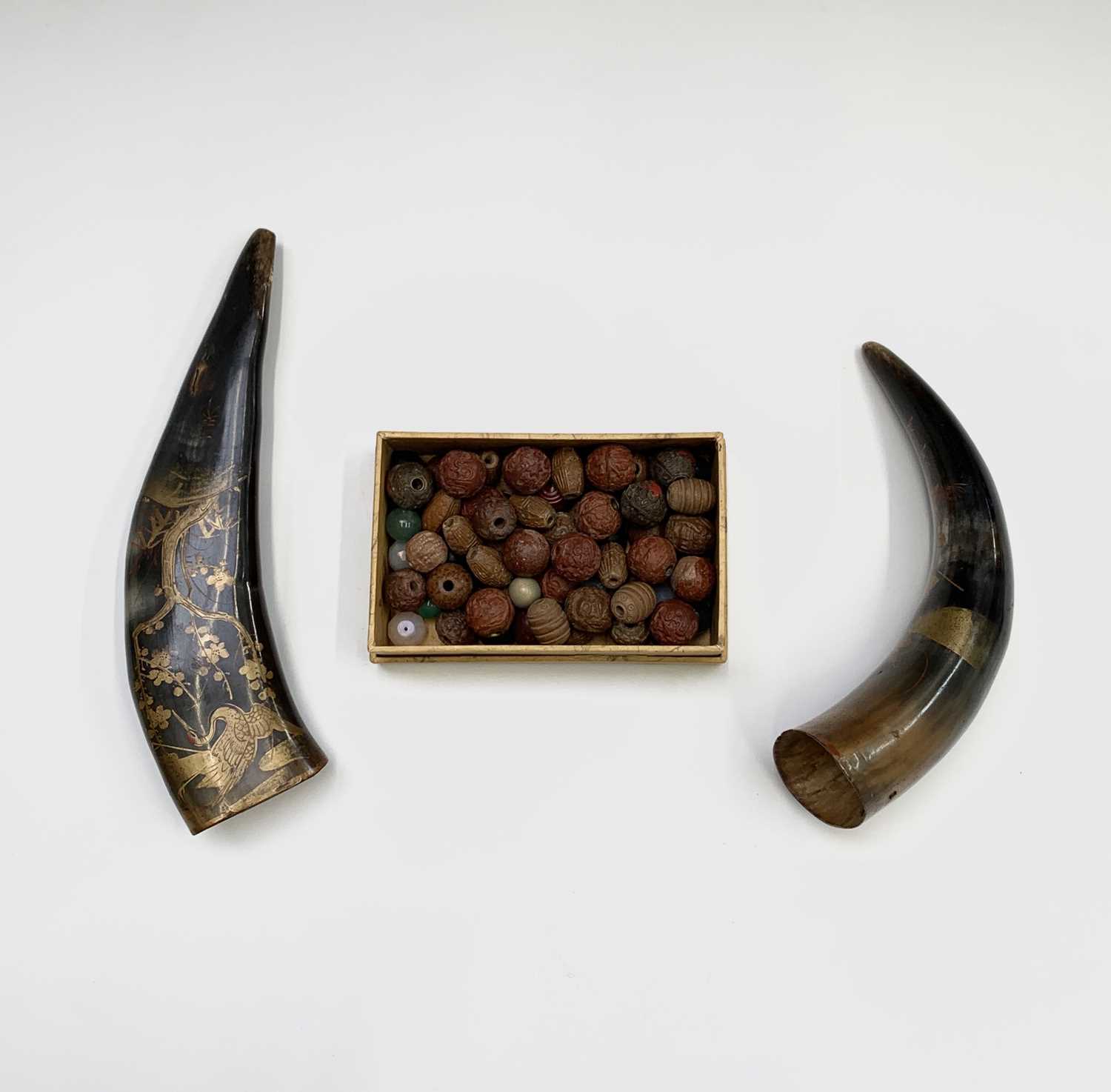 Two Japanese gilt lacquered horns, signe, largest 22cm and a quantity of beads, mainly carved wood.