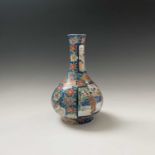 A Japanese porcelain bottle vase, circa 1890, red six character mark, the blue ground with flowering