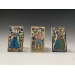 Three Persian Qajar pottery tiles, 19th century, each with a figure amongst foilage, 13 x 7.5cm.