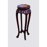 A Chinese stained carved wood jardiniere stand, 20th century, with inset marble top on curvilinear