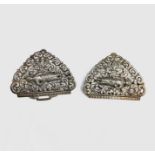 A Burmese silver two-piece belt buckle, stamped arabic script, each with a standing deity amongst