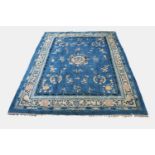 A Chinese Peking carpet, the indigo field with a central circular medallion enclosing a dragon,