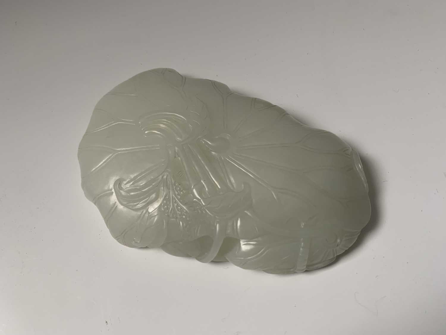 A Chinese white jade 'lotus leaf' brushwasher, 19th Century, height 2.5cm, width 13cm, depth 8.5cm. - Image 4 of 20