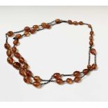 A long necklace of amber beads, length 73cm.Condition report: The beads are various sizes the