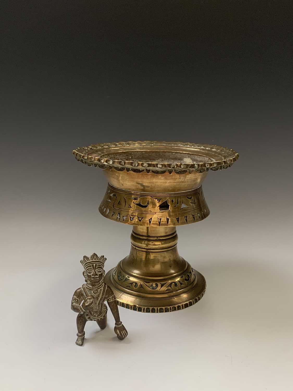 A Burmese circular pierced brass stand, 19th century, height 22.5cm, diameter 24.5cm and a bronze