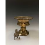 A Burmese circular pierced brass stand, 19th century, height 22.5cm, diameter 24.5cm and a bronze