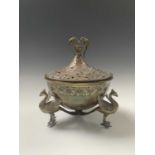 A Persian brass brazier, late 19th century, the pierced cover surmounted by a bird finial, the