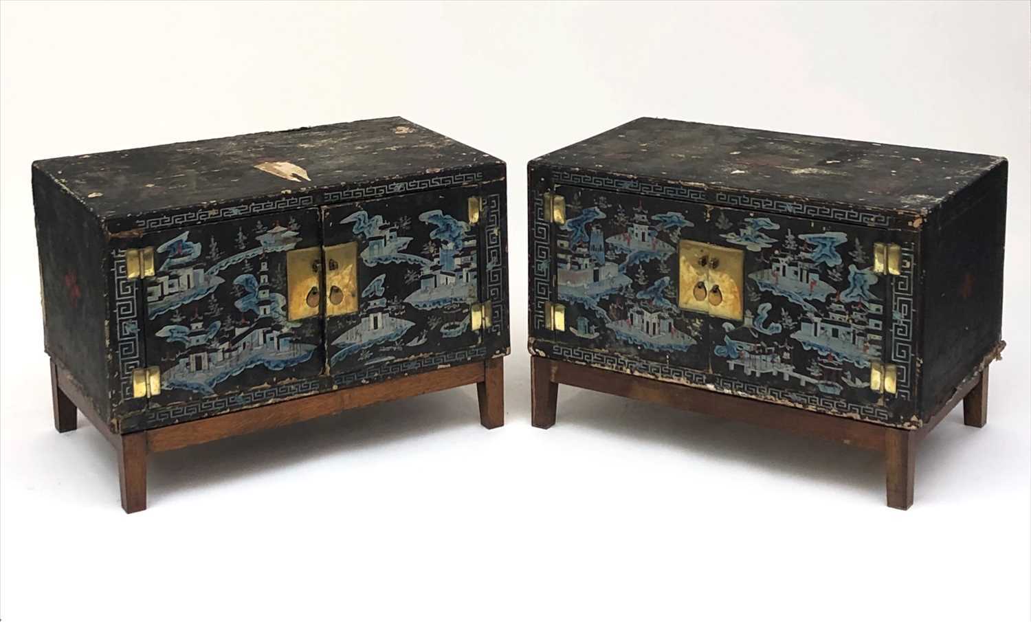 A pair of Chinese lacquered wood and painted cabinets, early 20th century, on later oak stands,