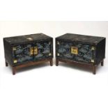 A pair of Chinese lacquered wood and painted cabinets, early 20th century, on later oak stands,