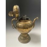 An Indian brass hot water jug, 18th/19th century, the hinged cover above a trellis engraved globular