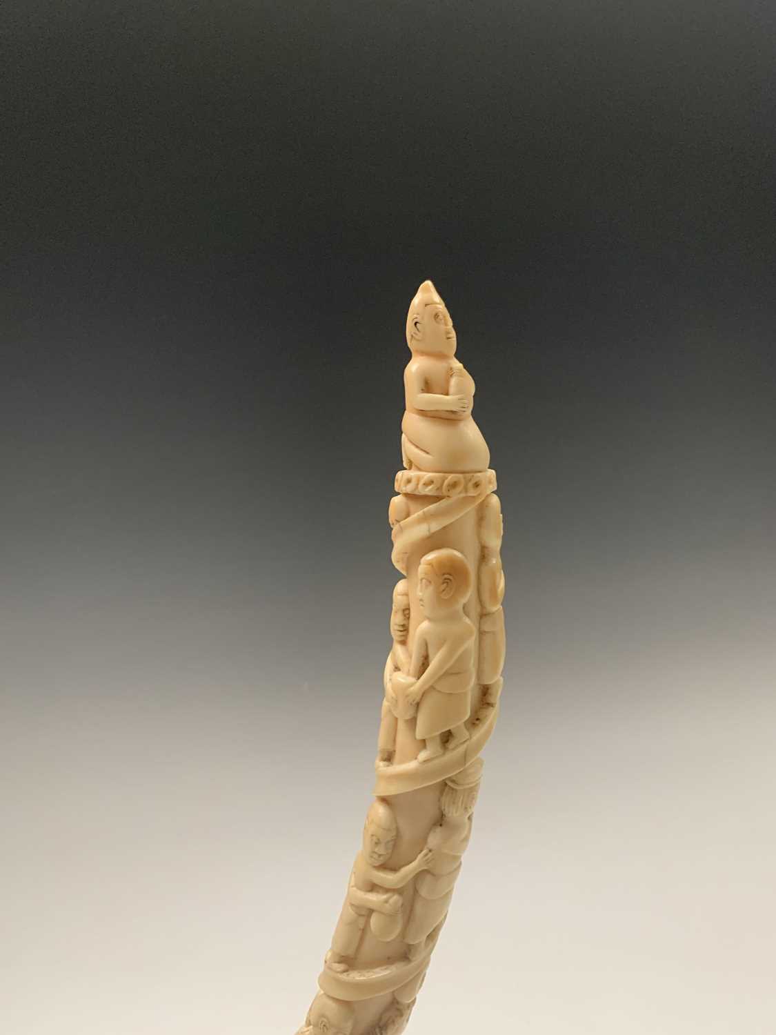 An African Loango ivory tusk, late 19th century, carved with porters some of which are carrying - Image 8 of 10