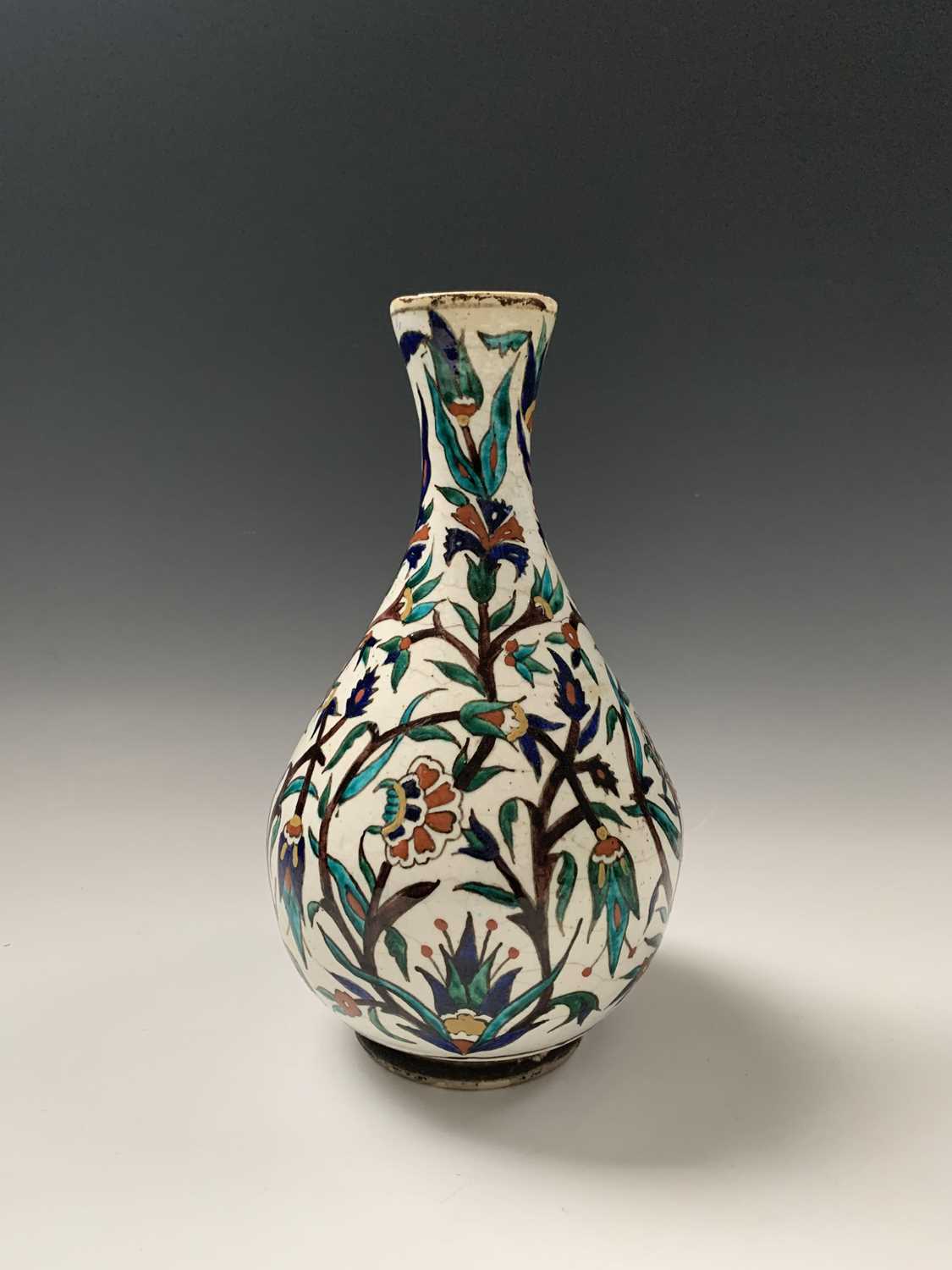 An Iznik pottery vase, 19th century, the bulbous body with a white ground and decorated with