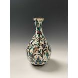 An Iznik pottery vase, 19th century, the bulbous body with a white ground and decorated with