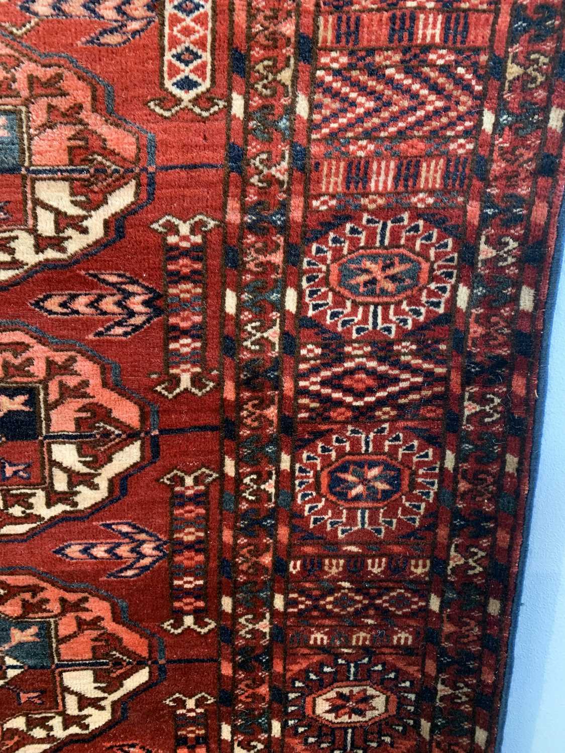 A Tekke carpet, Turkmenistan, circa 1890, the madder field with ten rows of five medallions, - Image 5 of 13