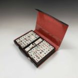 A Mahjong set, in black leather case, with 'Mah jong Handbook For Beginners, by 'Futami Kogeisha,