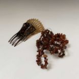 Two amber necklaces and two tortoiseshell combs.