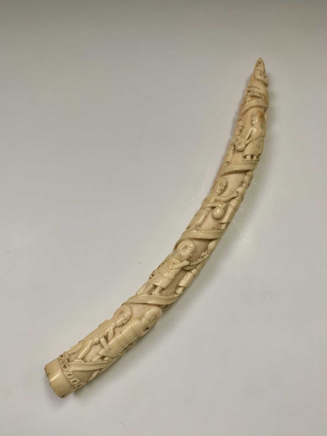 An African Loango ivory tusk, late 19th century, carved with porters some of which are carrying - Image 6 of 10