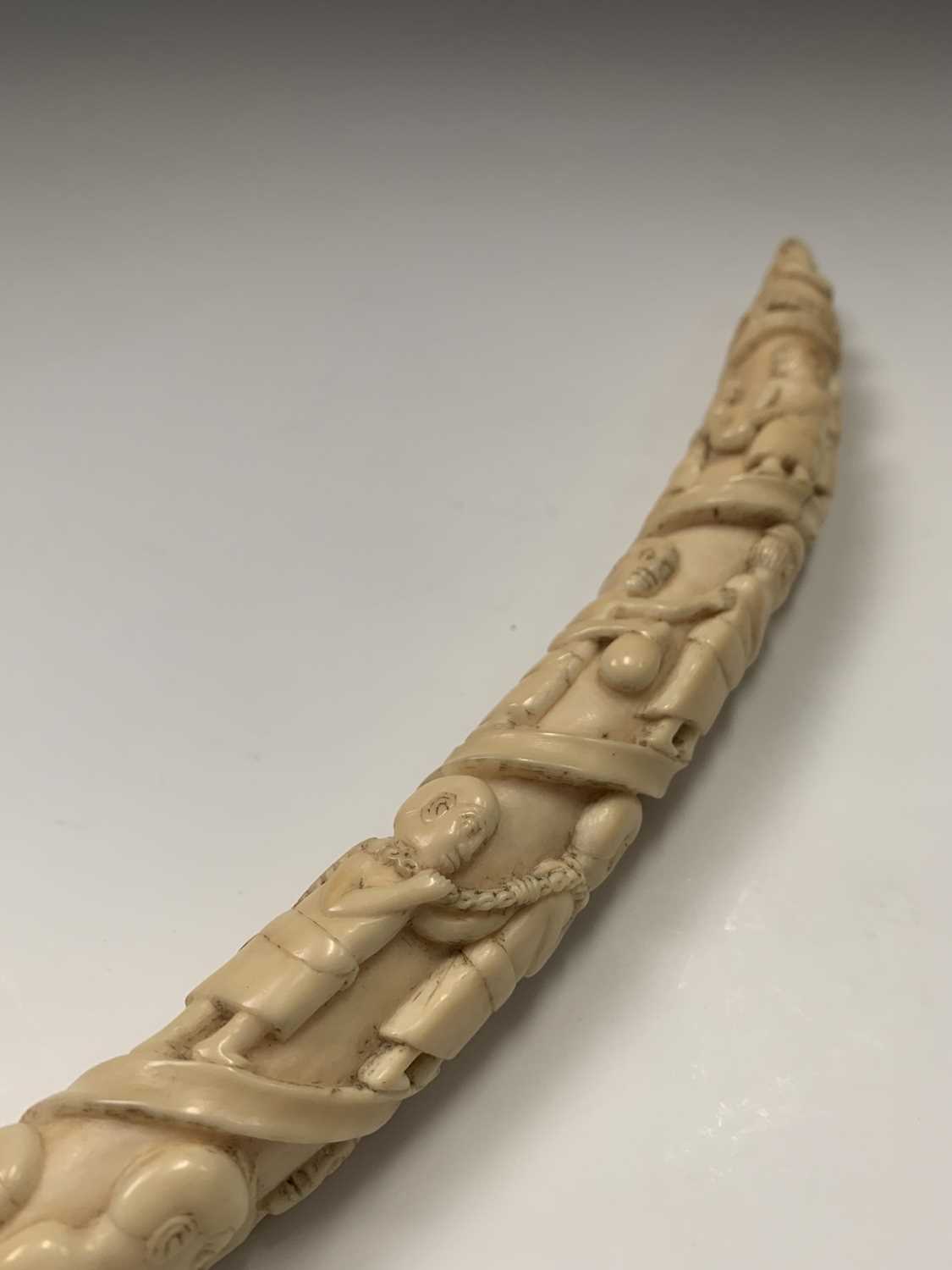 An African Loango ivory tusk, late 19th century, carved with porters some of which are carrying - Image 10 of 10