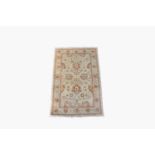 An Afghan Ziegler style rug, the ivory field with palmettes and flowering vines sprays, within an