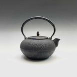 A Japanese iron tetsubin (iron tea kettle), Meiji Period, signed, height 19cm, length 20cm.