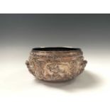 A Thai silver bowl, circa 1900, the body embossed with dieties and scrolling foliage, 448 grams,