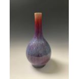 A Chinese flambe glazed bottle vase, 18th century, of crimson, blue, purple and lavender tone,
