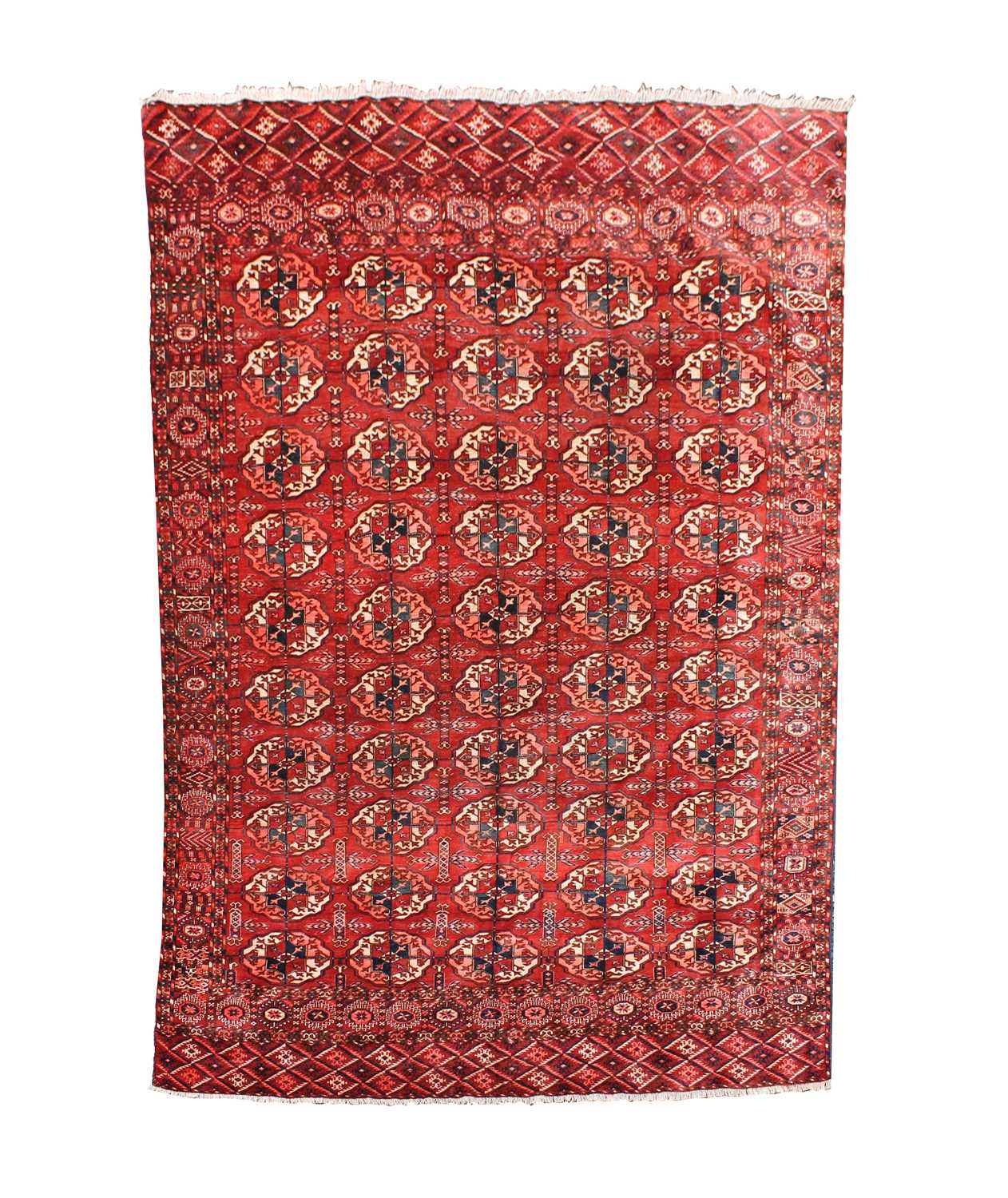 A Tekke carpet, Turkmenistan, circa 1890, the madder field with ten rows of five medallions,