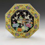 A Chinese porcelain octagonal charger, early 20th century, the central black ground with exotic