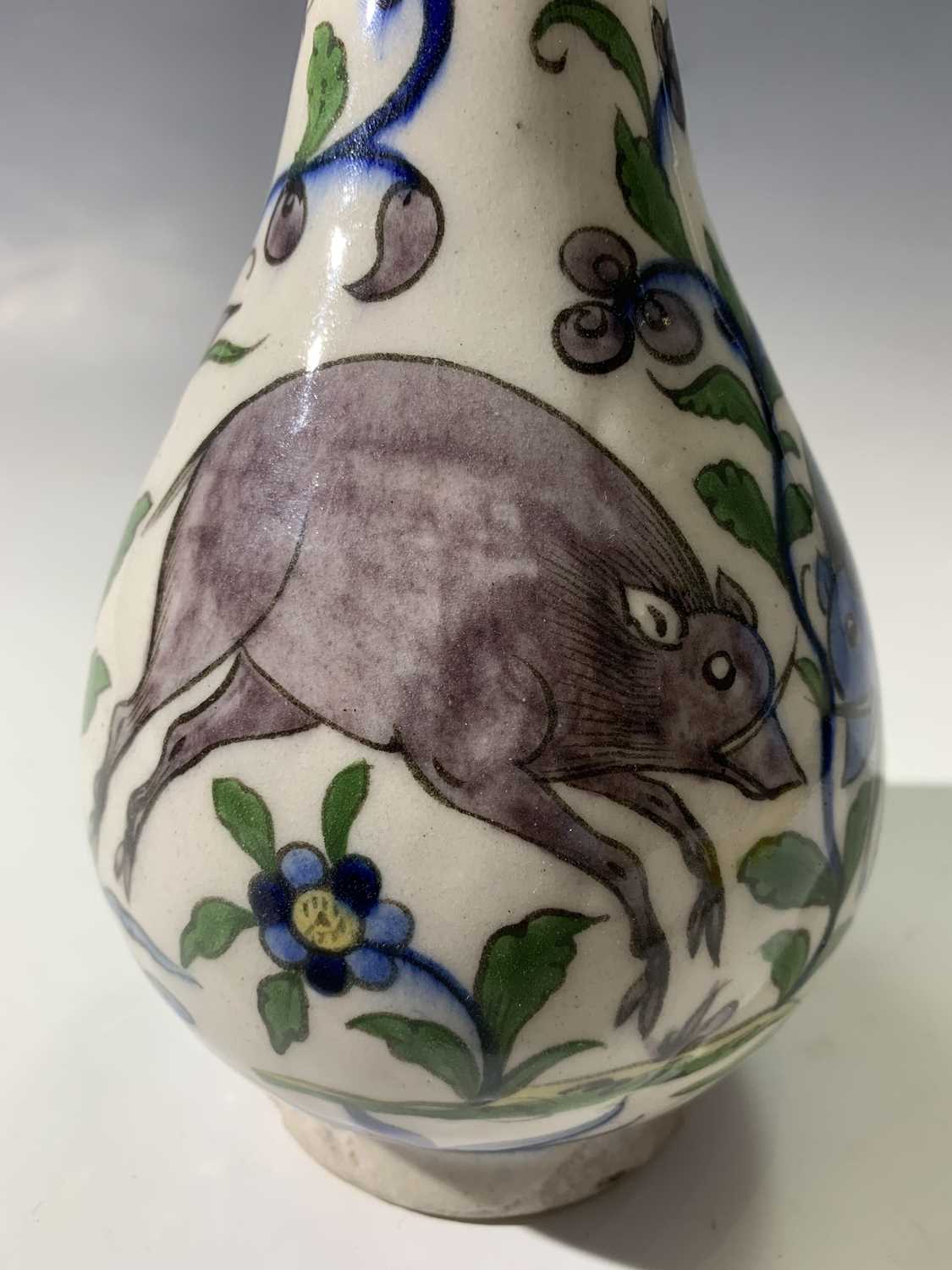 A Persian pottery bottle vase, circa 1900, the white ground with wild boar amongst stylised - Image 10 of 13