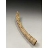 An African Loango ivory tusk, late 19th century, carved with porters some of which are carrying