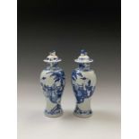 A near pair of Chinese blue and white baluster vases and covers, circa 1900, each decorated with