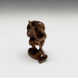 A Japanese carved wood netsuke, signed, 20th century, height 5.5cm.