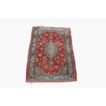 A Tabriz rug, North West Persia, the madder field with a sky blue and ivory central medallion,