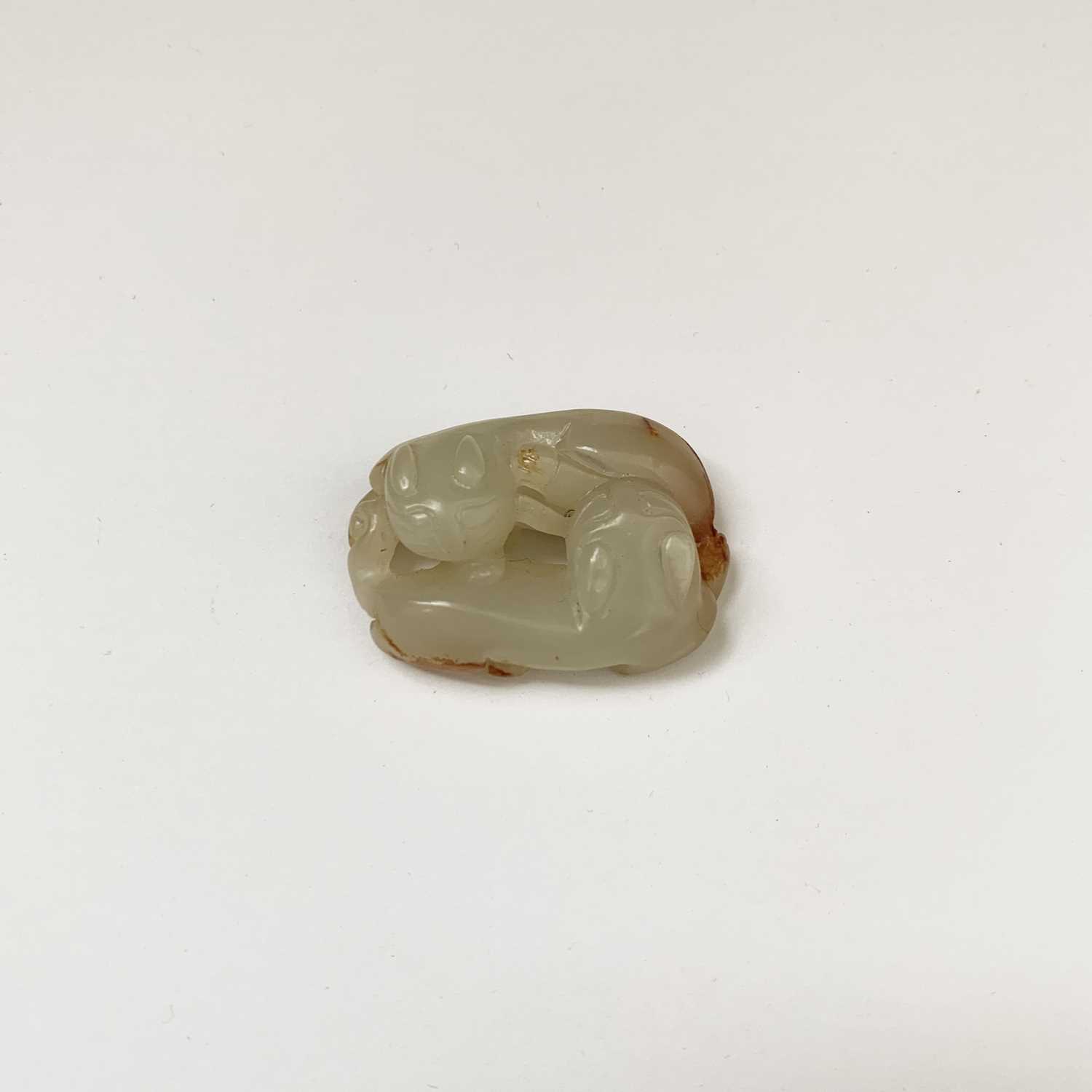 A Chinese jade carving of double felines, Qing dynasty, 4cm x 2.7cm.Condition report: UK postage: £