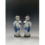 A pair of Chinese blue and white crackle glazed vases, with covers, circa 1900, each with figures in