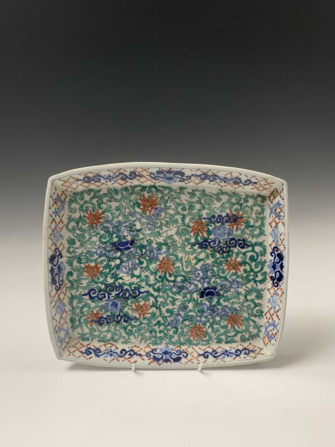 A Chinese porcelain tray, Qing period, the scrolling foliate decoration with red and gilt palmettes,