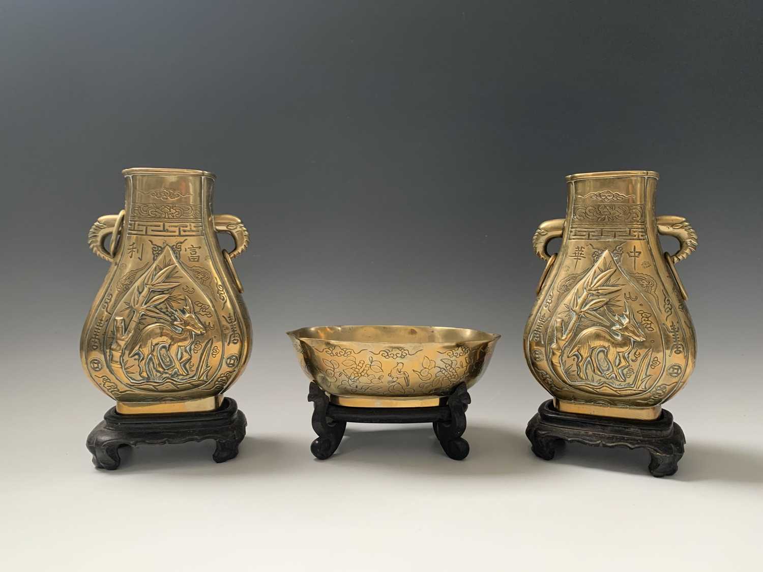 A pair of Chinese bronze pear-shaped vases, circa 1900, each with a dragon chasing the pearl to