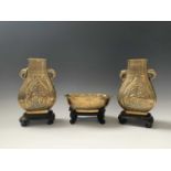 A pair of Chinese bronze pear-shaped vases, circa 1900, each with a dragon chasing the pearl to