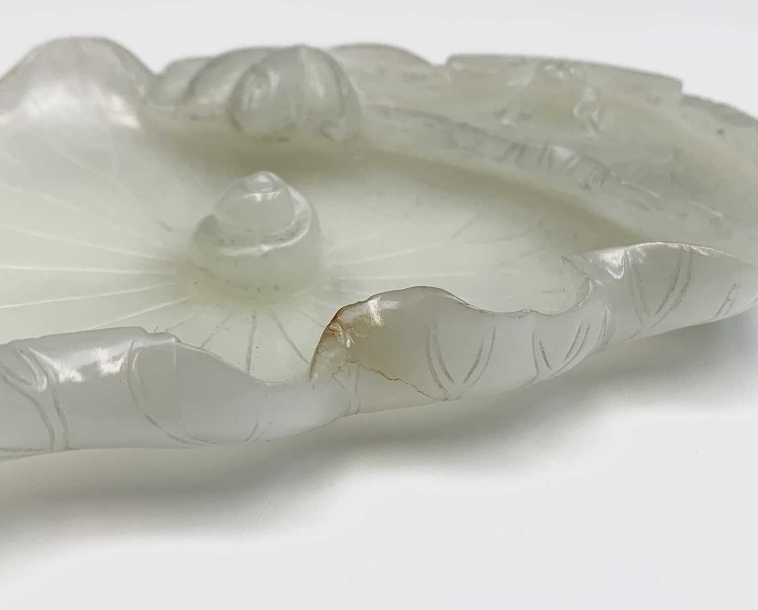 A Chinese white jade 'lotus leaf' brushwasher, 19th Century, height 2.5cm, width 13cm, depth 8.5cm. - Image 12 of 20