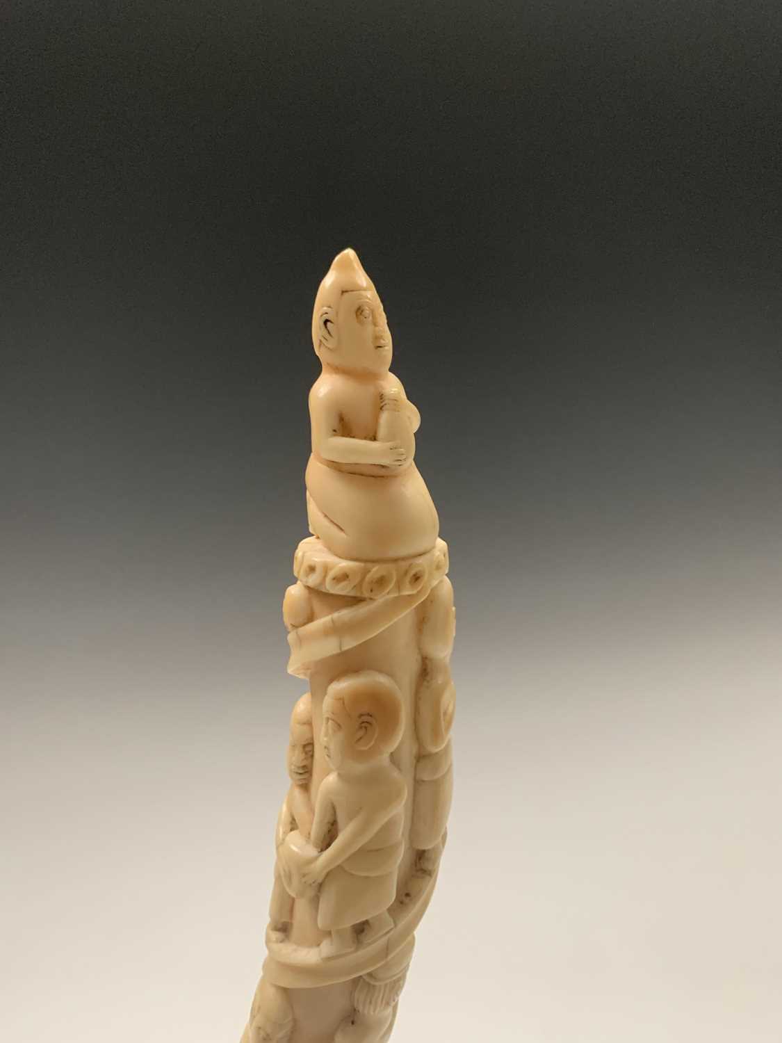 An African Loango ivory tusk, late 19th century, carved with porters some of which are carrying - Image 5 of 10