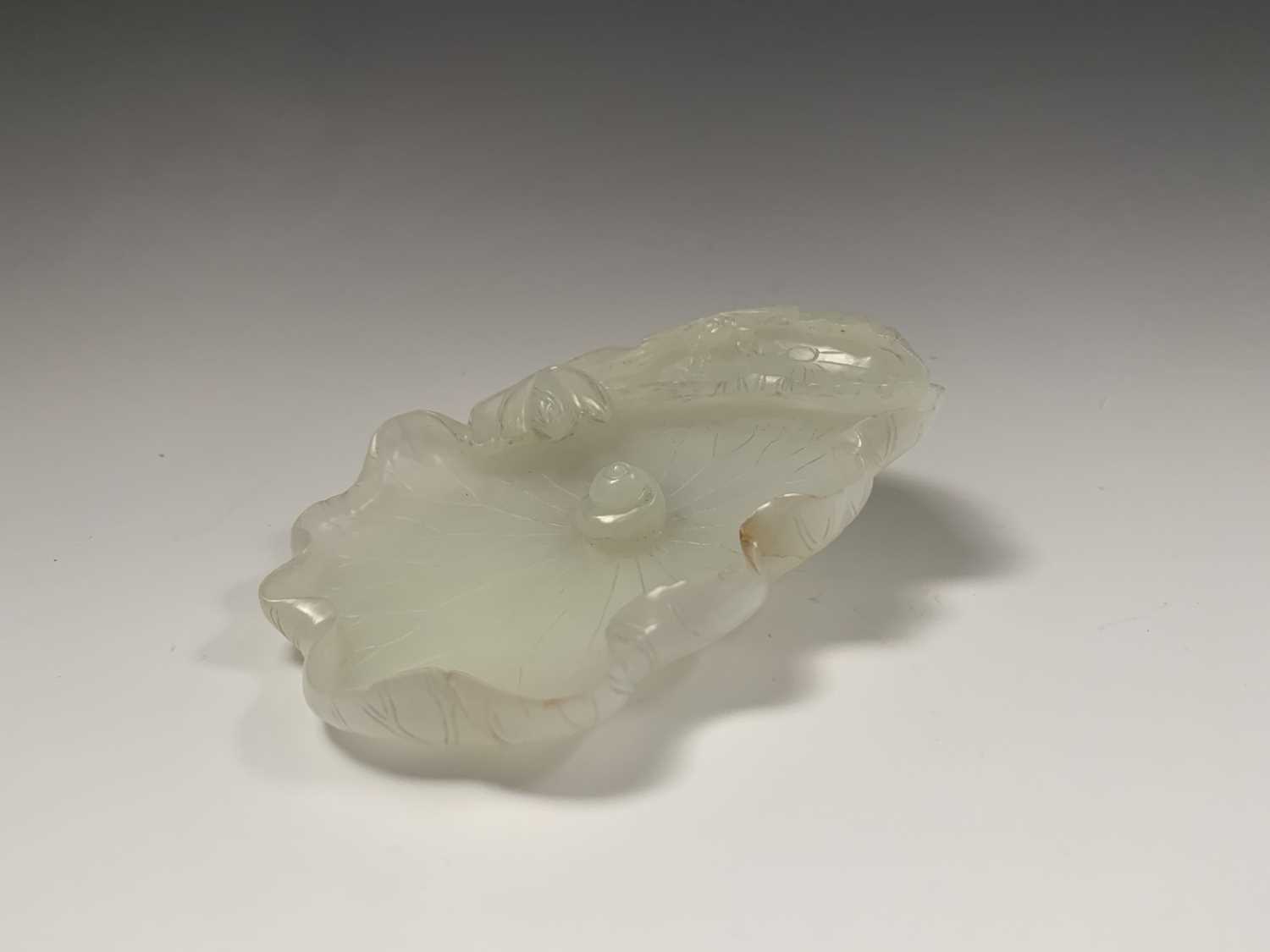 A Chinese white jade 'lotus leaf' brushwasher, 19th Century, height 2.5cm, width 13cm, depth 8.5cm.