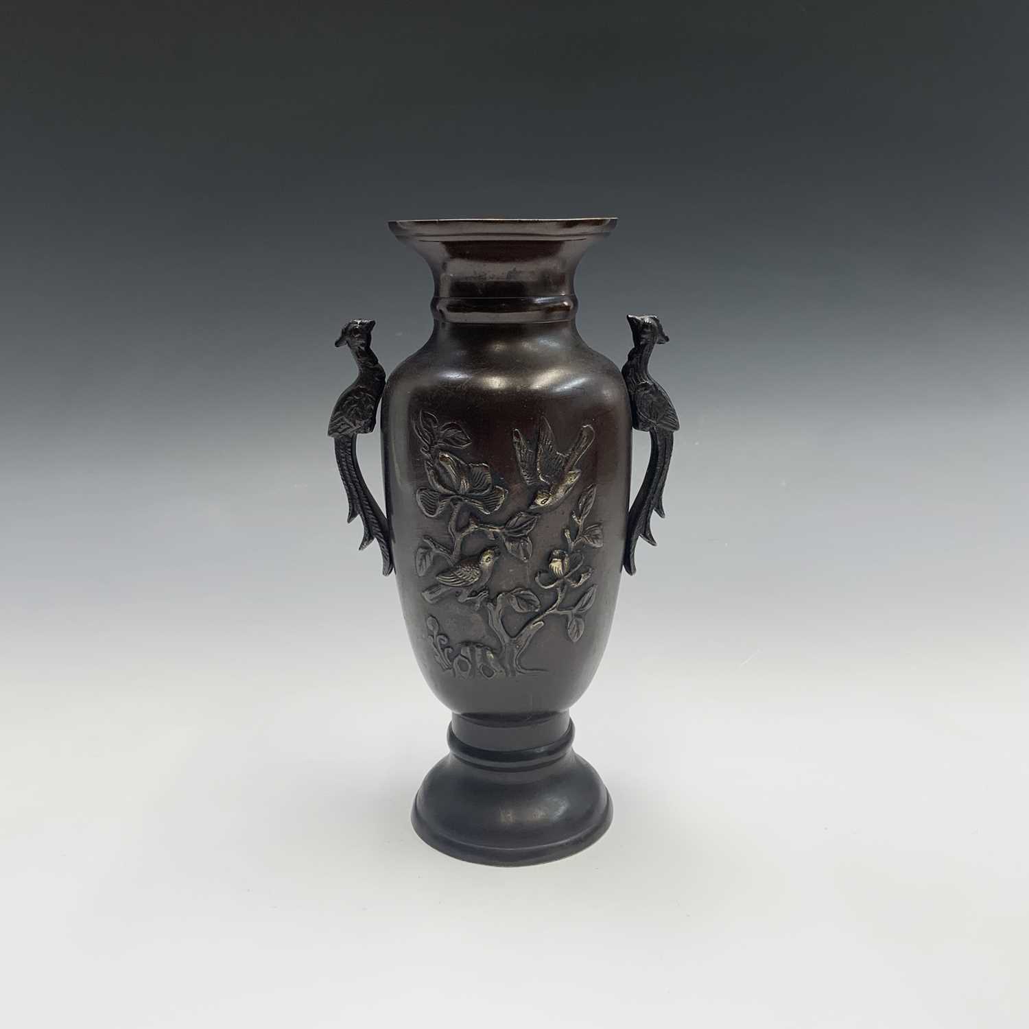 A Japanese bronze twin-handled vase, Meiji Period, the body with trees and birds, height 26cm.