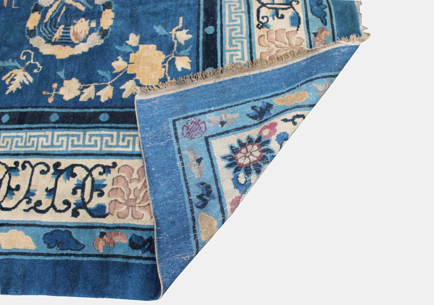 A Chinese Peking carpet, the indigo field with a central circular medallion enclosing a dragon, - Image 2 of 2