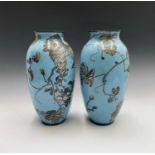A pair of Japanese cloisonne vases, 19th century, each with a pale blue ground with birds perched on