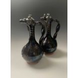 A near pair of Canakkale black lustre glazed pottery ewers, 19th century, Ottoman Turkey, each