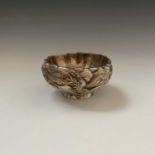 A Chinese silver footed bowl, signed, 240 grams, decorated with a three clawed dragon on a wave