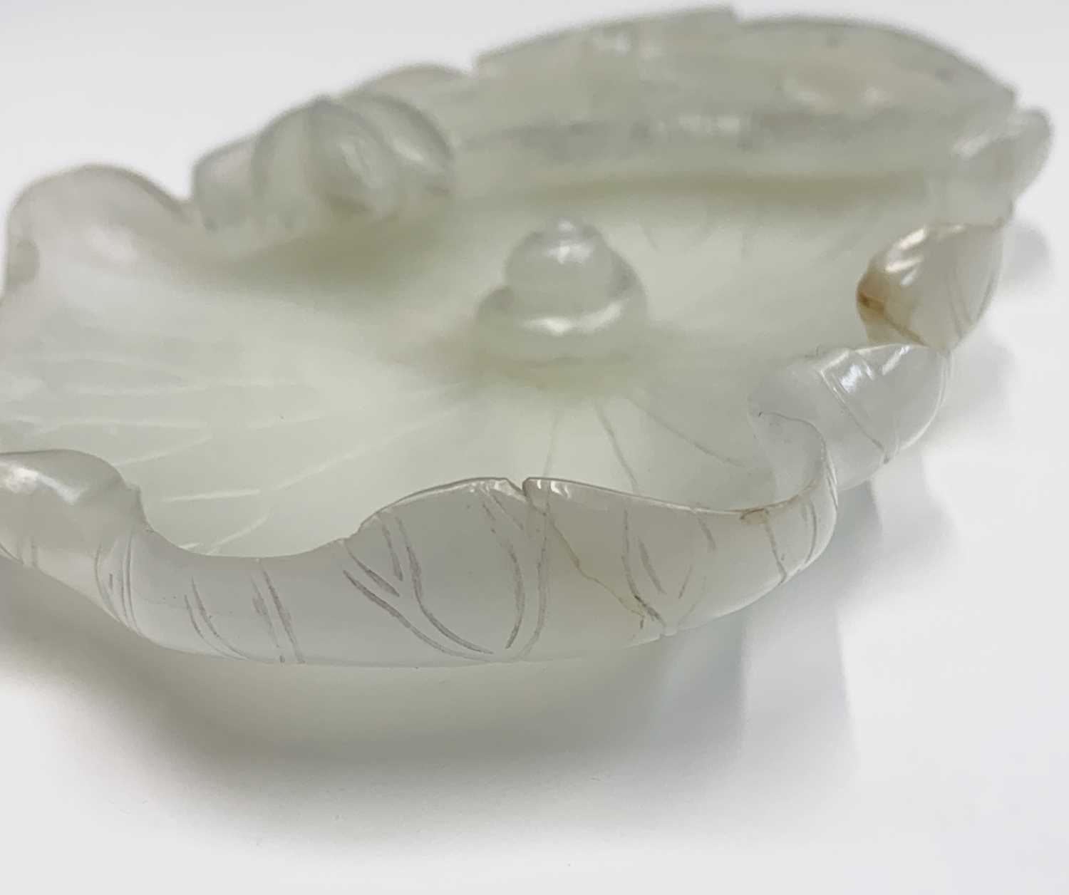 A Chinese white jade 'lotus leaf' brushwasher, 19th Century, height 2.5cm, width 13cm, depth 8.5cm. - Image 9 of 20