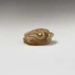 A Chinese carved jade figure of a feline, with reddish veining, Qing dynasty, height 2cm, width 5.