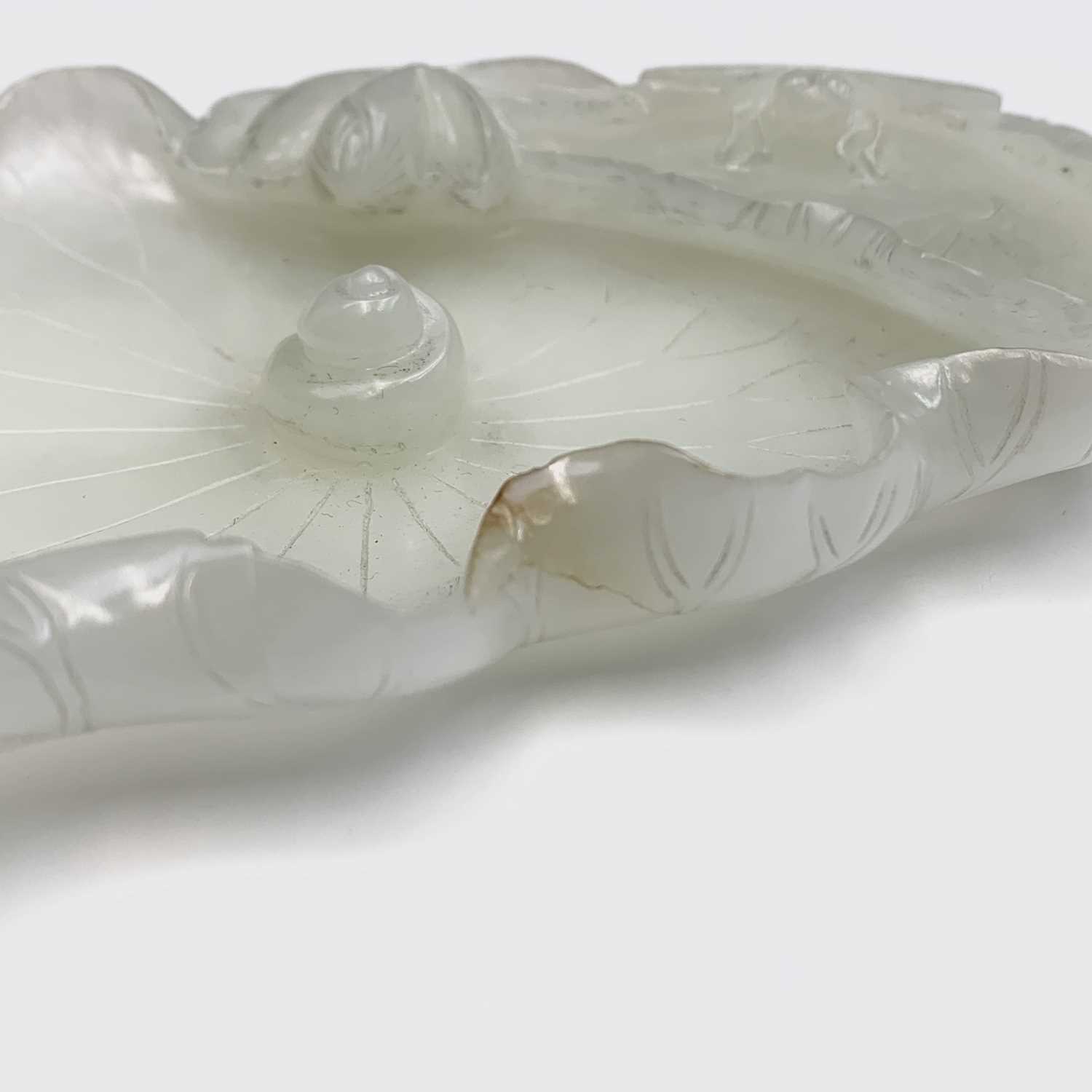 A Chinese white jade 'lotus leaf' brushwasher, 19th Century, height 2.5cm, width 13cm, depth 8.5cm. - Image 7 of 20